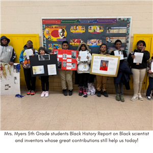5th Graders holding science projects.